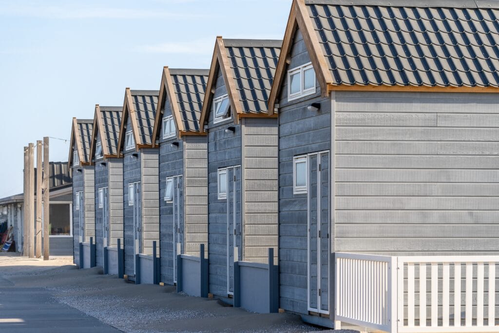 Beautiful shot of resting cabins on a sand beach
